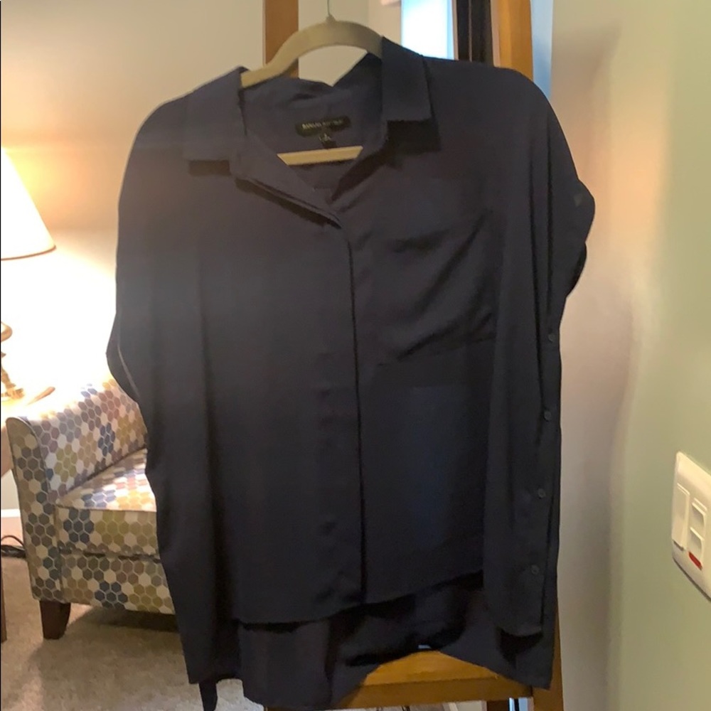 Oversized blouse button down sides front pocket.